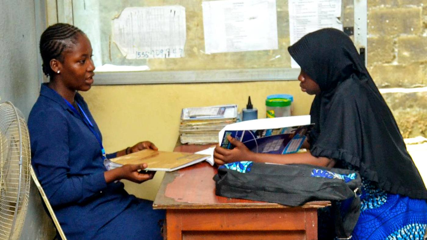 Geosolution staff member assisting a student with admission paperwork