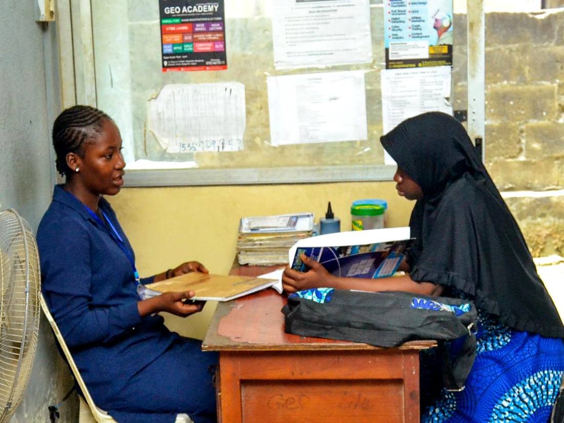 An adviser helping a student with admission paperwork